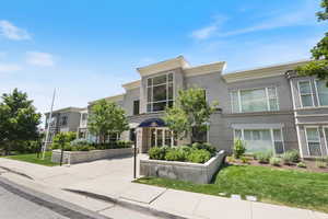 View of front facade featuring stucco siding and a front lawn