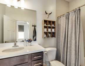 Full bath featuring shower / bath combo and vanity