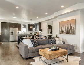 Living area featuring recessed lighting and dark wood-type flooring