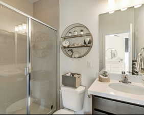 Full bath with a stall shower and vanity