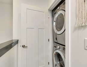 Laundry room with stacked washer and clothes dryer