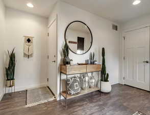Entryway with recessed lighting and dark wood finished floors