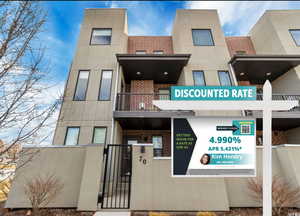 View of property with a fenced front yard. Discounted rate with seller contributing for a permanent rate buy down