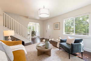 Living area featuring with beautiful natural light, stairway to upper level.