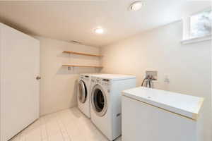 Laundry room with washer/dryer and chest freezer included with sale.