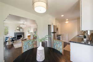 Dining area and kitchen with recessed lighting.