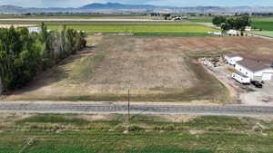 Aerial view of sparsely populated area featuring mountains and large plots for crops