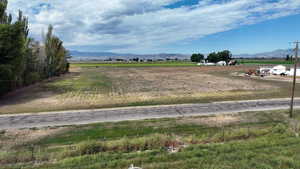 View of yard with a mountain view and a view of rural / pastoral area