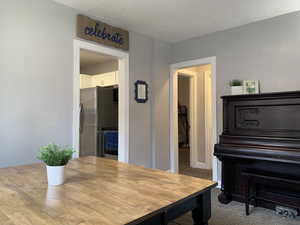 Dining room featuring carpet and a textured ceiling