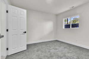 Spare room with carpet floors and baseboards