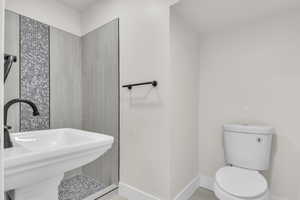 Bathroom featuring a sink and a tile shower