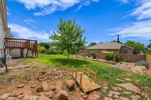 View of yard with a deck and stairs