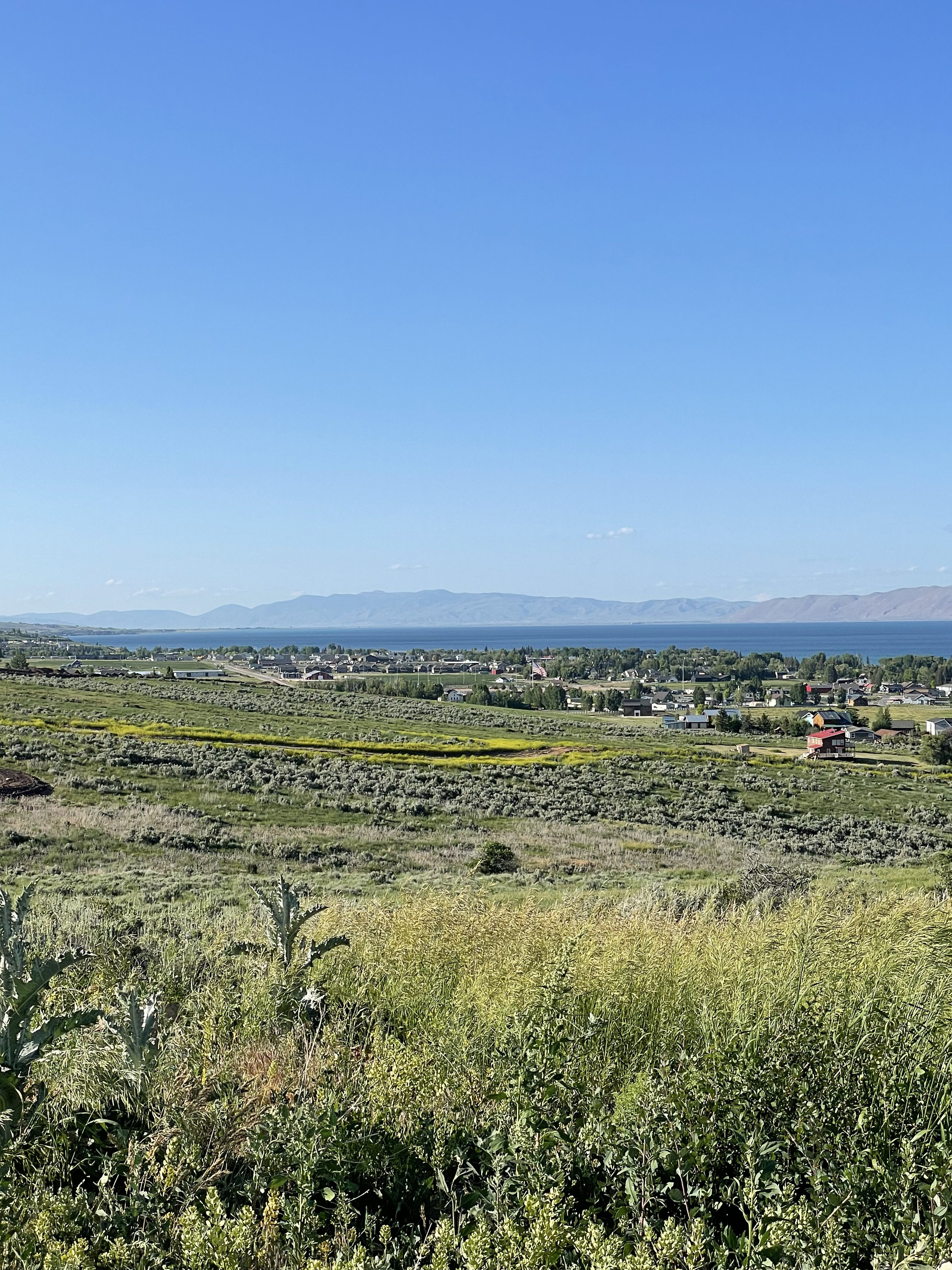 View of undeveloped land featuring mountains and lake