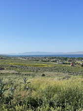 View of undeveloped land featuring mountains and lake