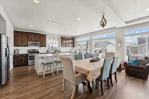 Dining room with dark wood-style flooring, recessed lighting, and a textured ceiling