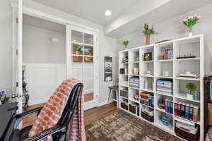 Office with wood finished floors and wainscoting