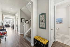 Entryway with stairs, dark wood-type flooring, recessed lighting, and a textured ceiling