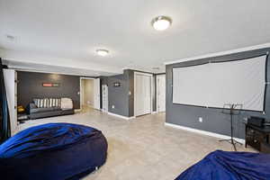 Bedroom featuring a textured ceiling and crown molding
