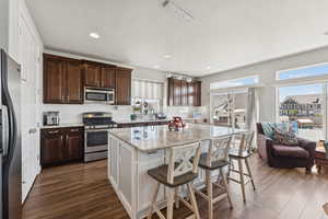 Kitchen featuring stainless steel appliances, plenty of natural light, a kitchen island, tasteful backsplash, and recessed lighting