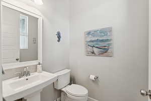 Half bathroom featuring a sink and toilet