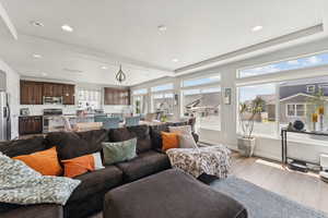Living area featuring wood finished floors, plenty of natural light, and recessed lighting