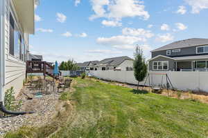 Fenced backyard with stairs, a residential view, and a deck
