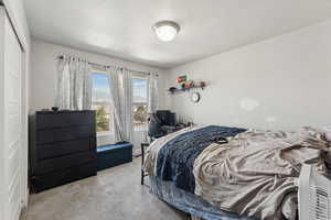 Bedroom with carpet and a textured ceiling