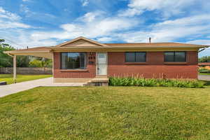 Ranch-style home with brick siding and driveway