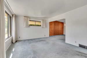 Unfurnished room with carpet