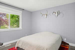 Bedroom with baseboards and wood finished floors