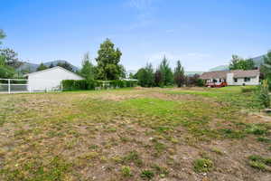View of yard featuring a deck with mountain view