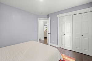 Bedroom featuring wood finished floors and a closet