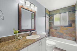 Full bath with vanity, tub / shower combination, and wood finished floors