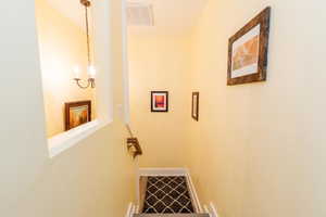 Hallway featuring an upstairs landing and baseboards