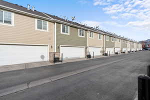 Back of property with a residential view and a garage