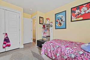 Bedroom featuring a closet and light wood-style floors