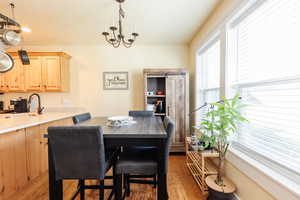Dining space featuring wood finished floors and a chandelier