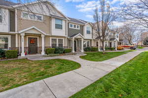 View of front facade featuring a residential view, stone siding, and a front yard