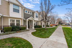View of front of house featuring a residential view, stone siding, and a front yard