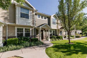 View of property featuring a front yard and stone siding