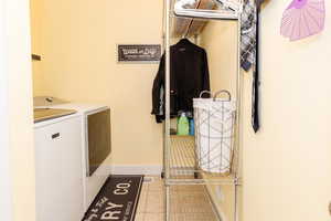 Laundry area featuring independent washer and dryer and tile patterned flooring