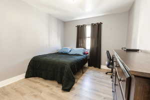 Bedroom featuring light wood-style flooring and baseboards