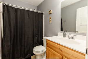 Bathroom featuring vanity, a shower with curtain, and a textured ceiling