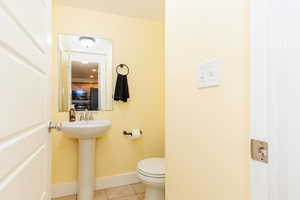 Bathroom with baseboards and tile patterned flooring