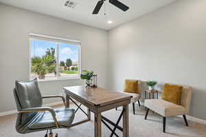 Office featuring light colored carpet, ceiling fan, and recessed lighting