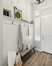 Mudroom with wood finished floors and baseboards