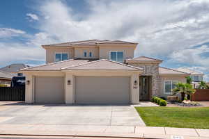 Prairie-style home with a garage, concrete driveway, stucco siding, and a tile roof