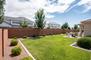 Fenced backyard with a patio