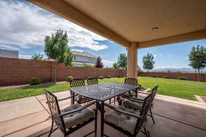 Fenced backyard with outdoor dining space and a patio