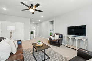 Living area featuring a ceiling fan, carpet, and recessed lighting